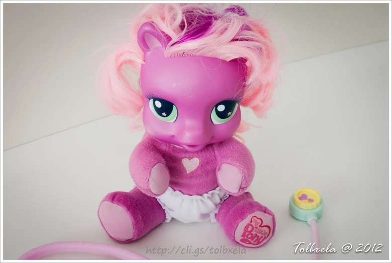 a pink pony has bright pink hair and blue eyes