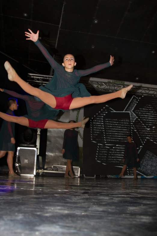 a boy is dancing in a dance pose