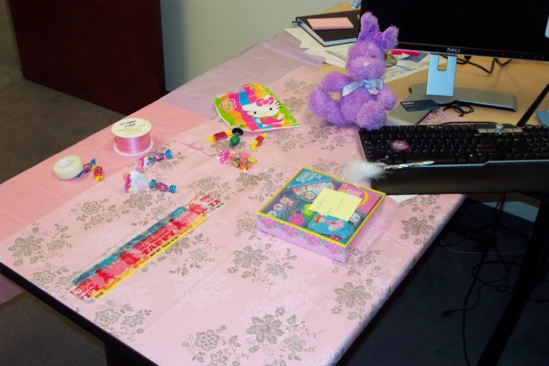 a laptop sitting on top of a table with toys