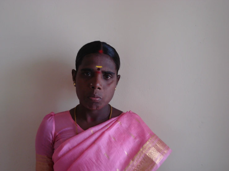 a young woman wearing a sari poses for the camera