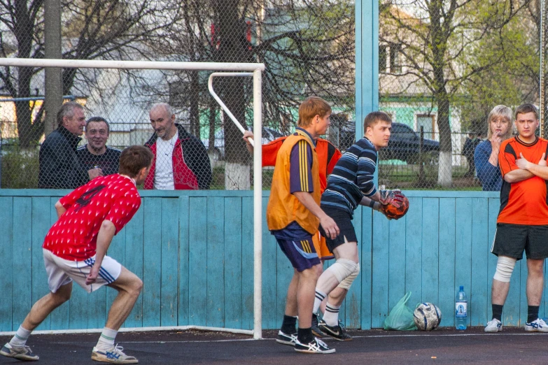 a group of young men playing soccer against each other