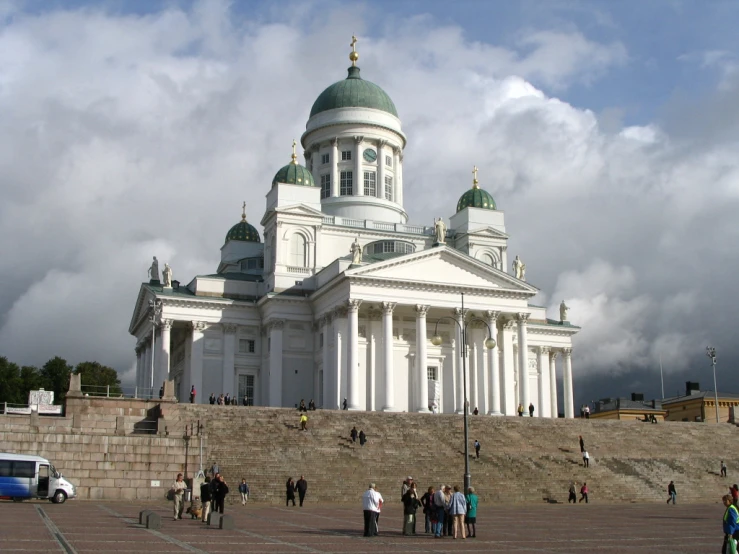 a group of people standing in front of a white building