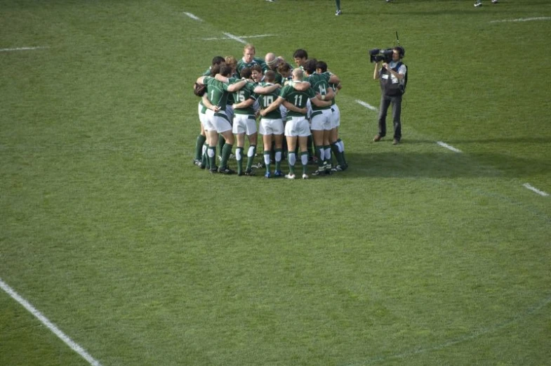 a group of men standing in the middle of a soccer field