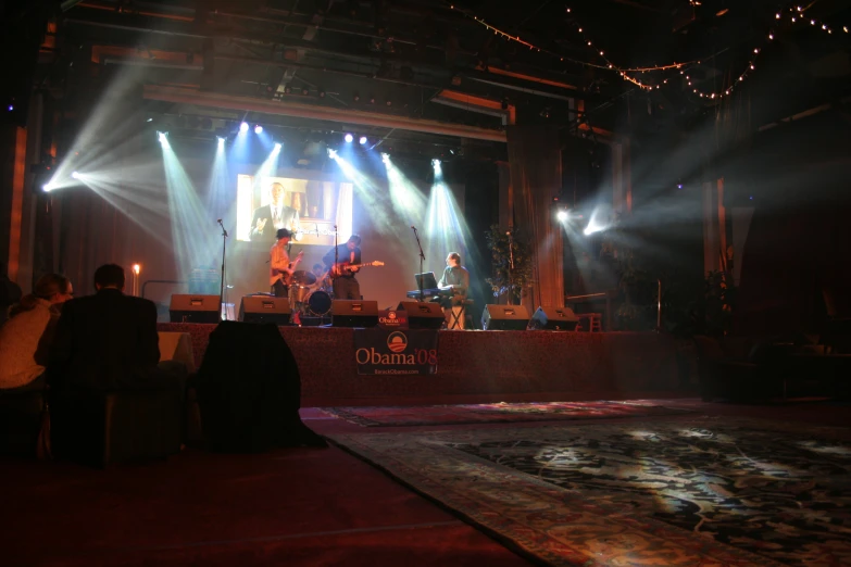 the stage is lit up with two band members on it