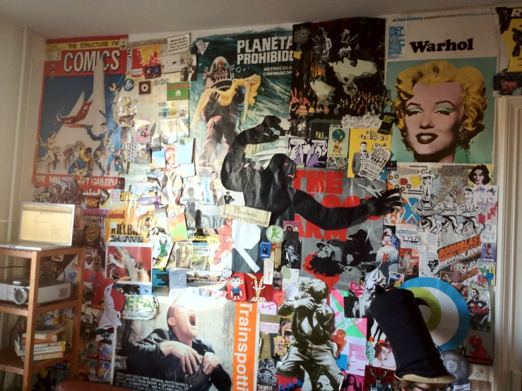 a bedroom with large wall covered in many different kinds of paper