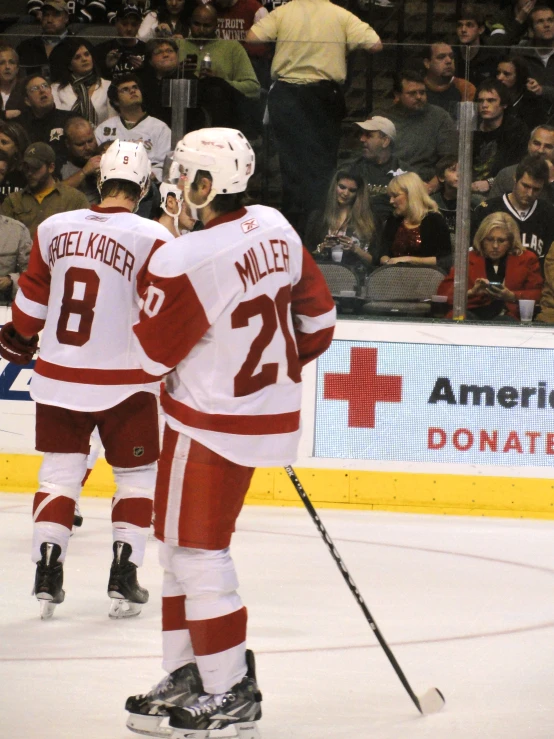 a couple of men that are standing on some ice