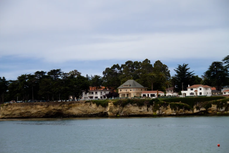 an old home sits near a body of water