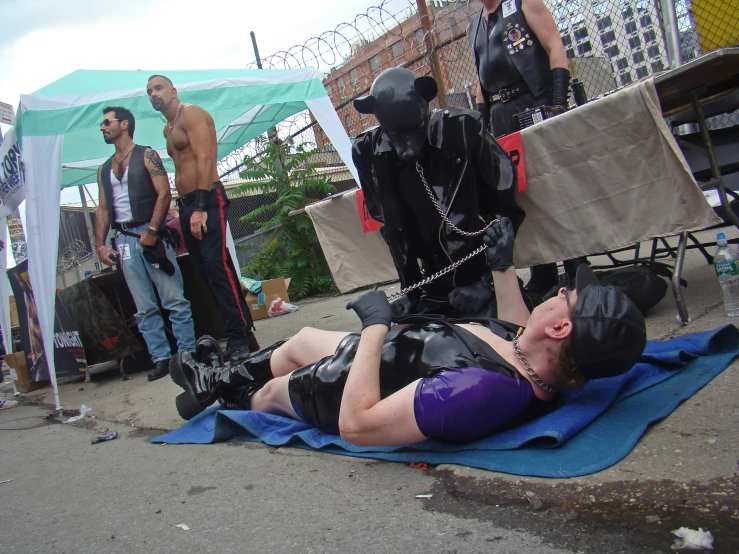 a man on a mat with chains strapped to his ankles