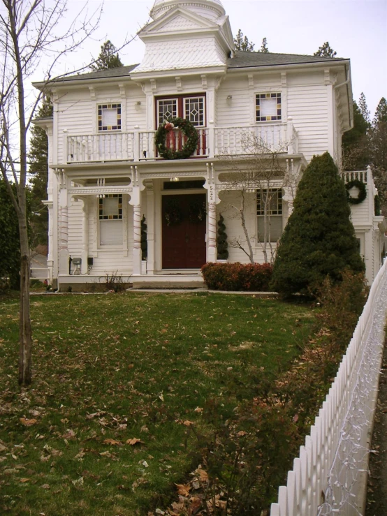 a large house sits on a leaf covered lawn