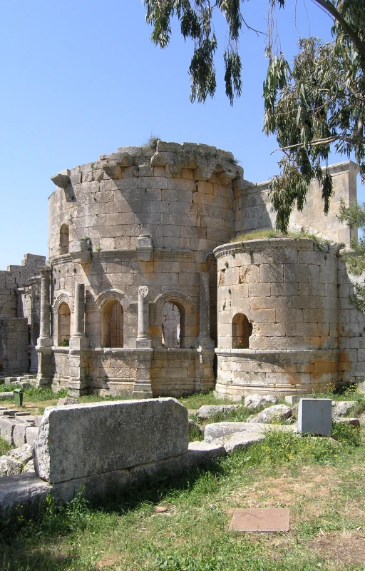 a large brick structure sitting next to a cement wall