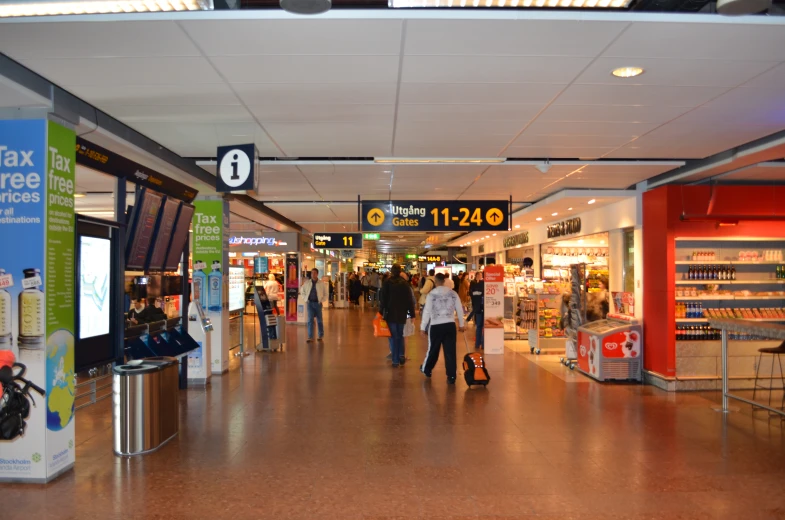 several people are walking in a large shopping mall