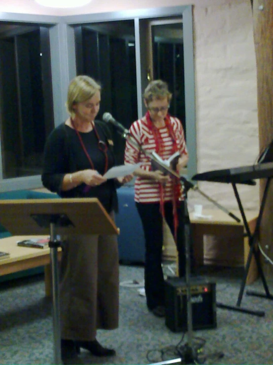 two women at a podium in a music room