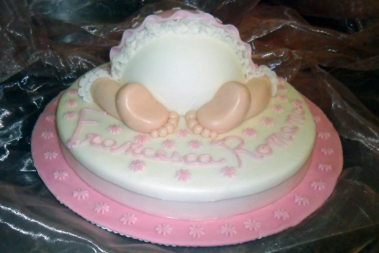 a cake is made with a two baby feet cake