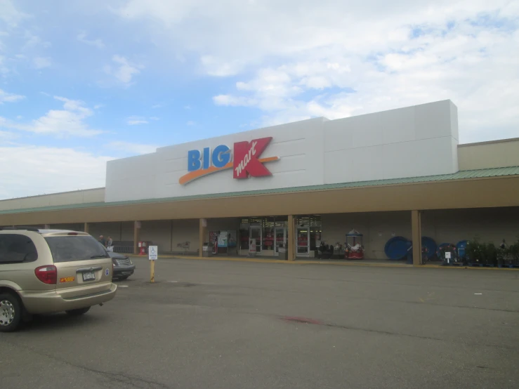 a big k convenience store with a white truck parked in front