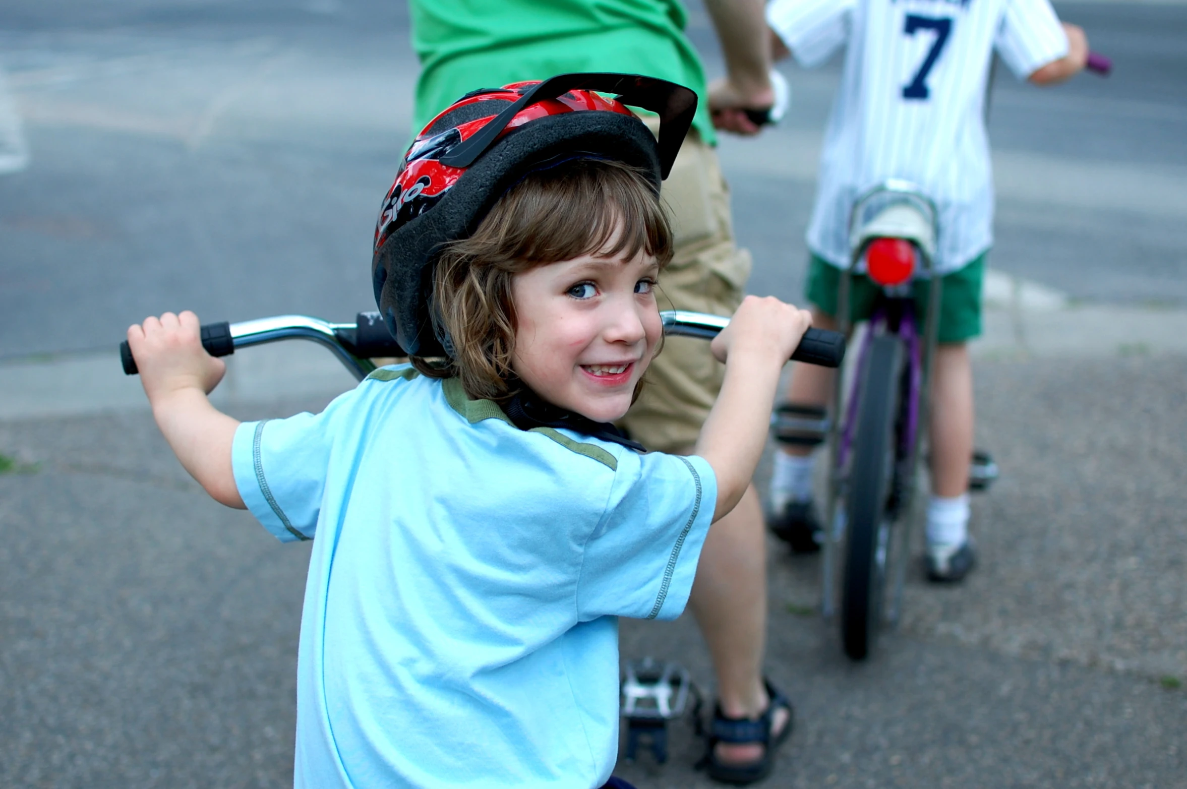 three boys are in line on their bikes