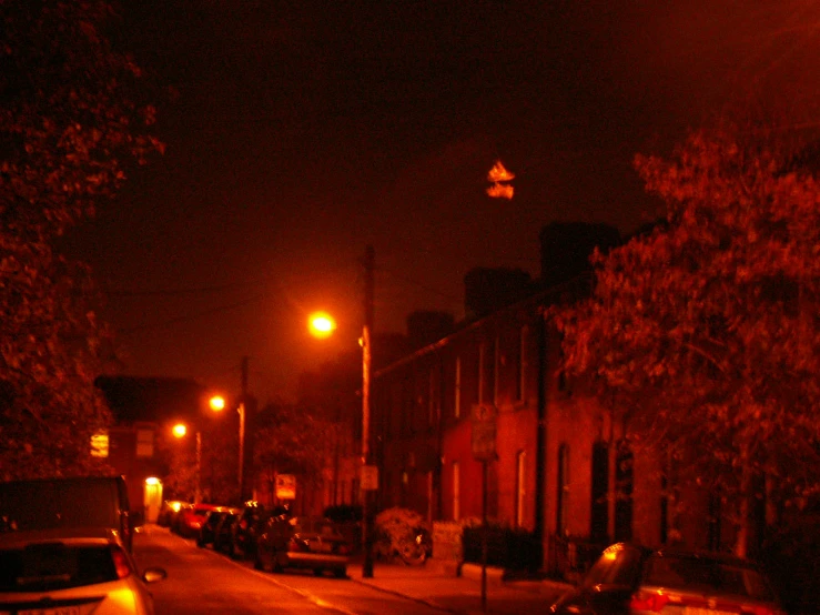 an empty city street at night with no cars parked on it