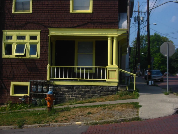 a fire hydrant near the curb of a house