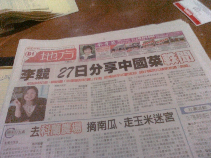 a newspaper with news paper showing news articles