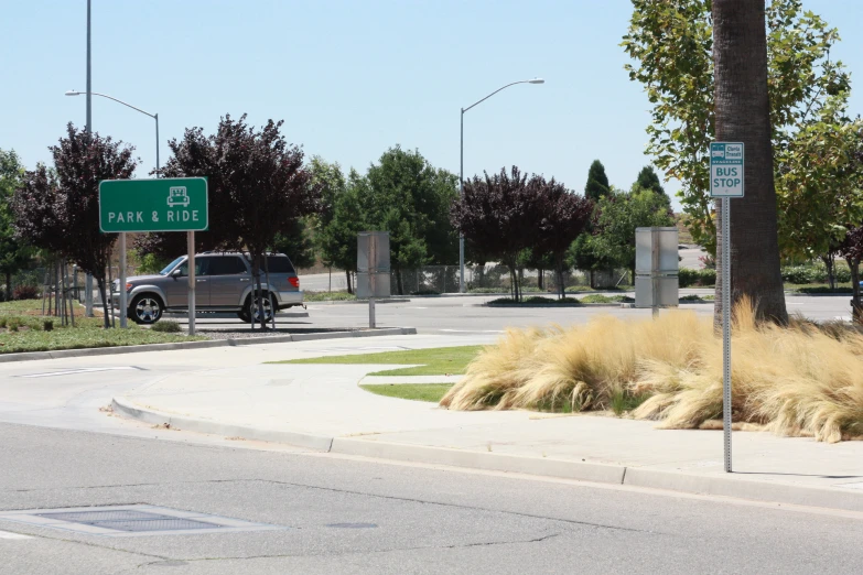 the cars are driving along the street with grass