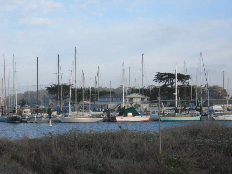 there are many sailboats sitting in a harbor