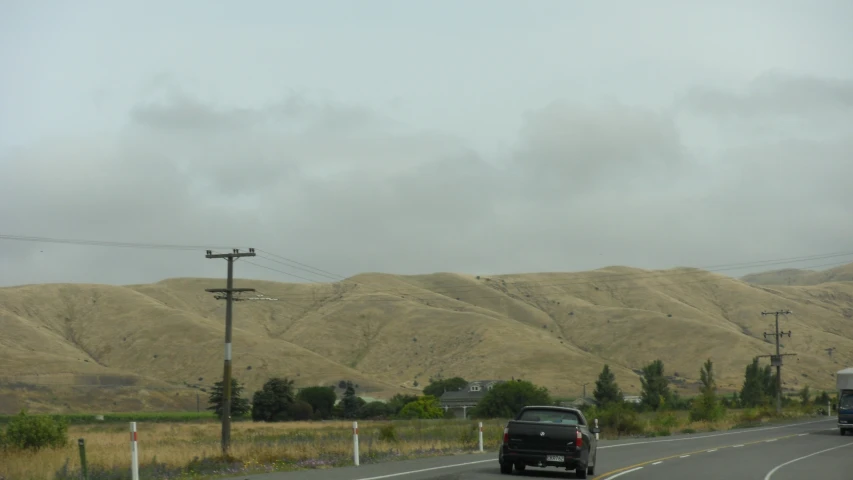 a traffic light on a road near mountains