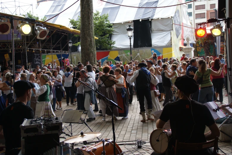 the group of musicians plays on the street