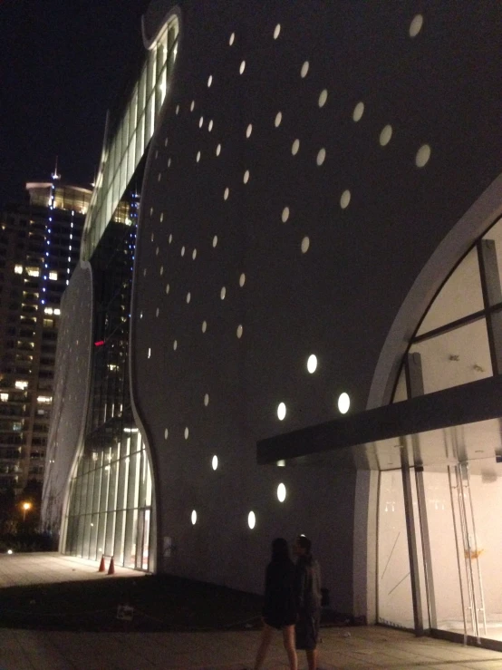 the lights are projected over a wall and outside the building