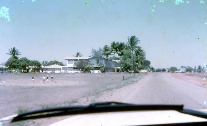 two people riding a bike on a dirt road