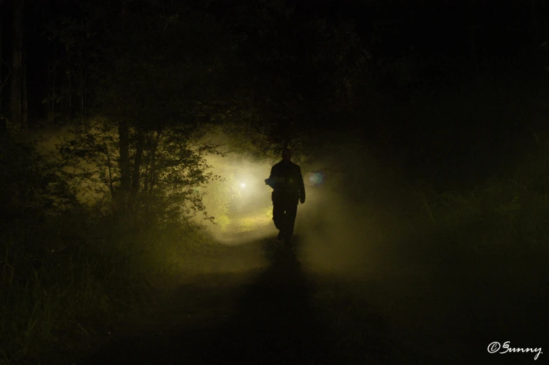 a person walking down a road at night