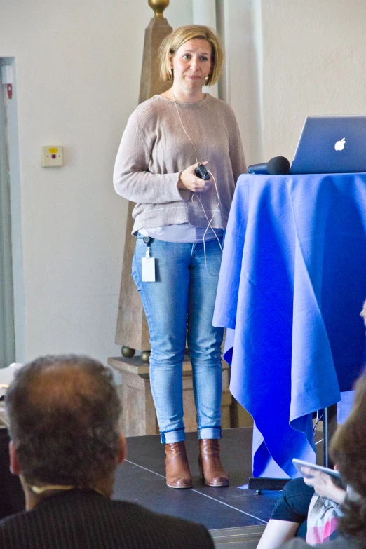 a woman giving a presentation at a seminar