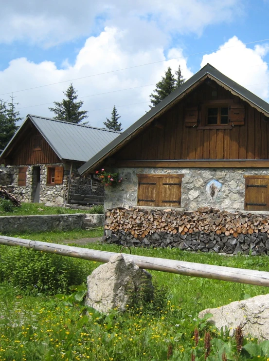 a stone house with wood doors and windows