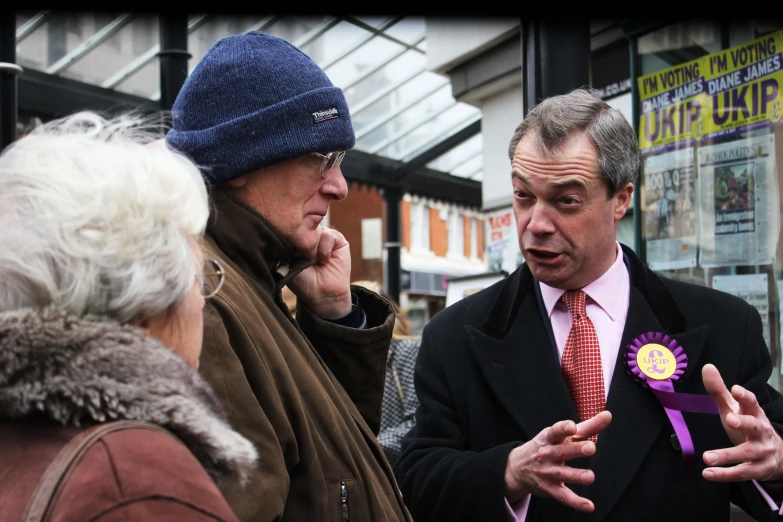 the man is holding the purple ribbon in his hand