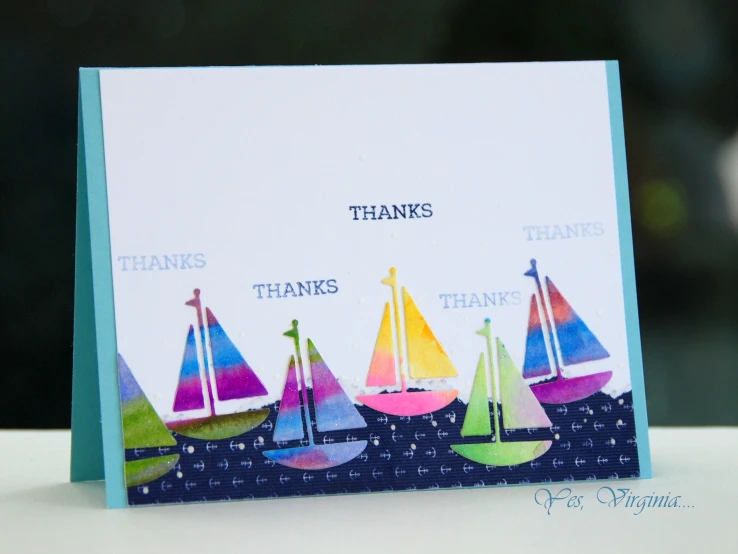 a card featuring paper sailboats on the sea