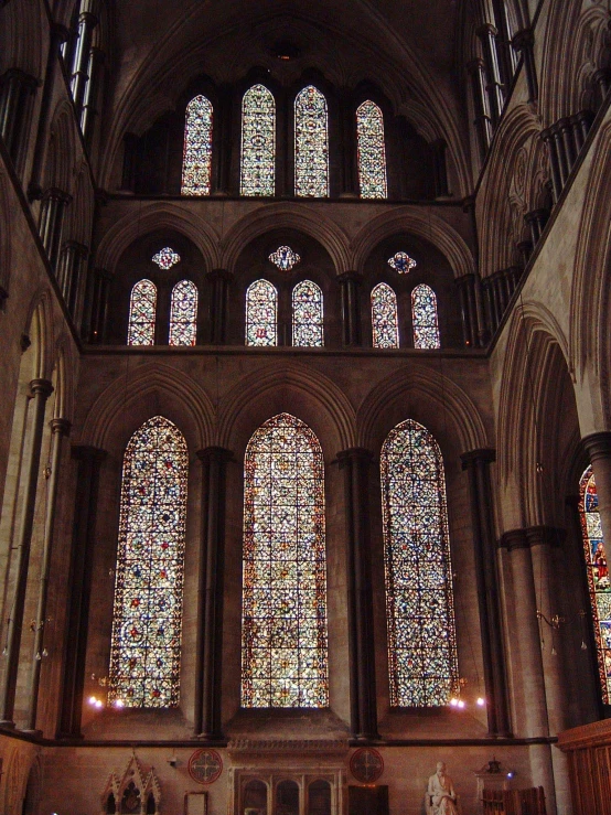 a cathedral with multiple stained glass windows and pews