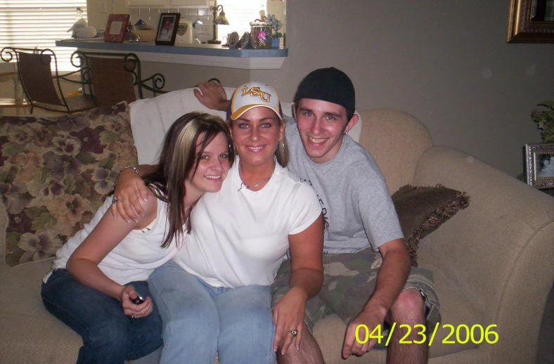 three friends taking a picture together sitting on a couch