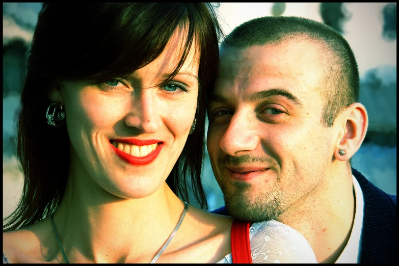 a man and a women are smiling with red lips