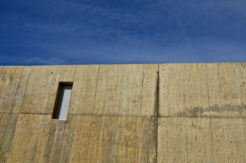 a long stone wall that has a window on top