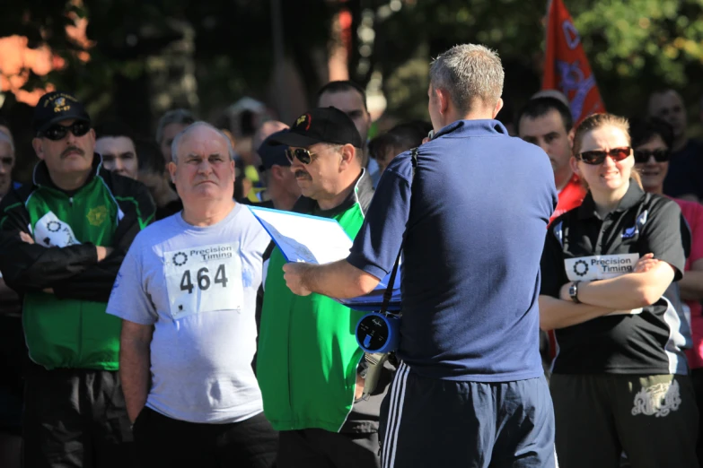 a man is at the finish line with his arms crossed