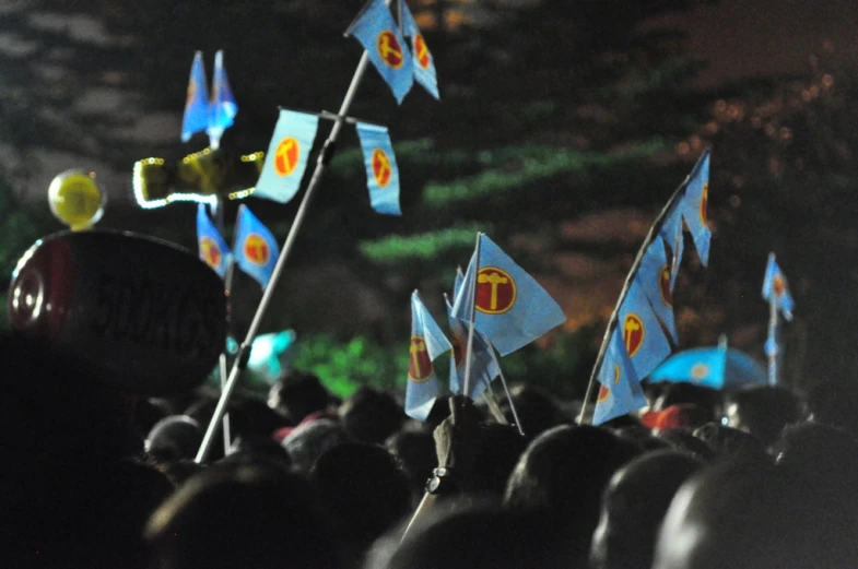 people watching a crowd of small flags