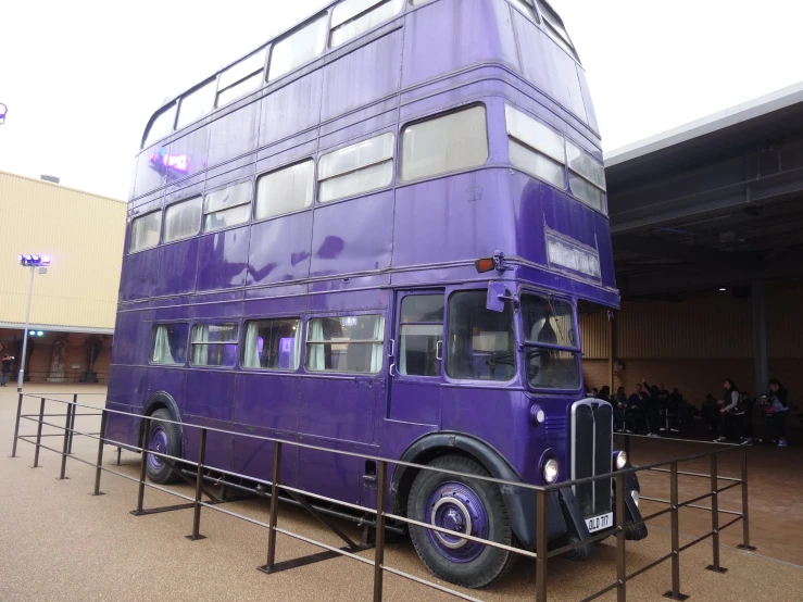 a double decker bus parked next to a building