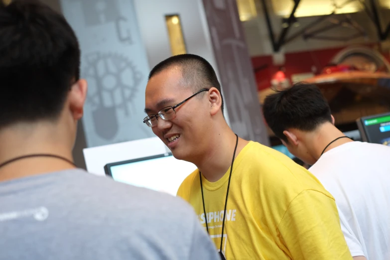 a man with headphones talking to another man