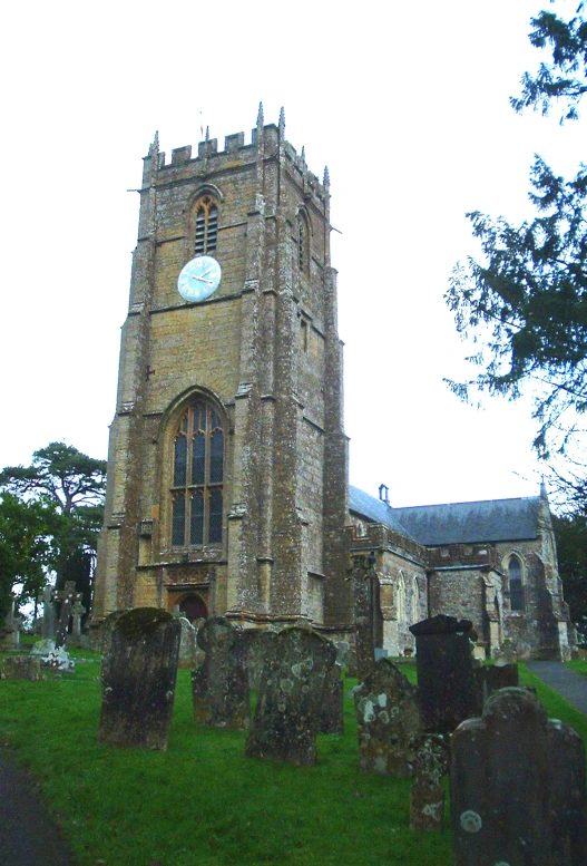 a large tall church with many graves in the foreground