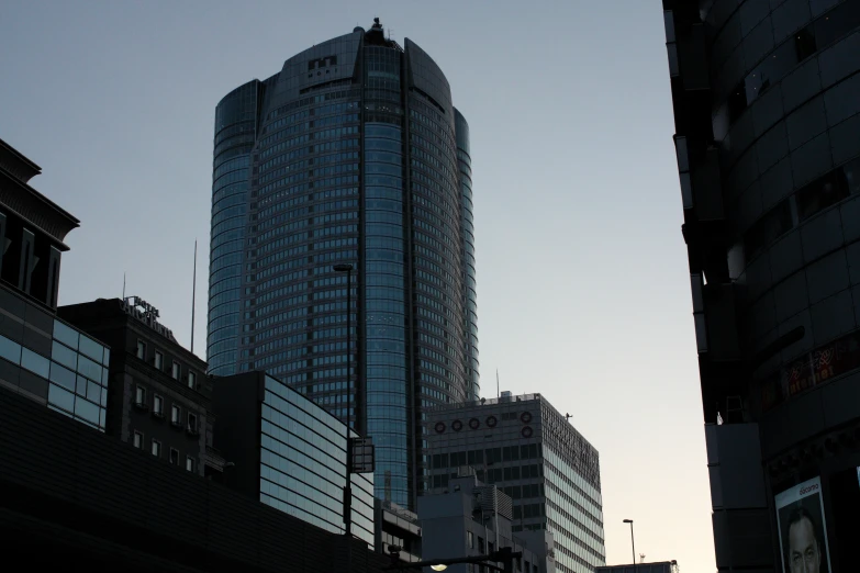 a tall building is against a twilight sky