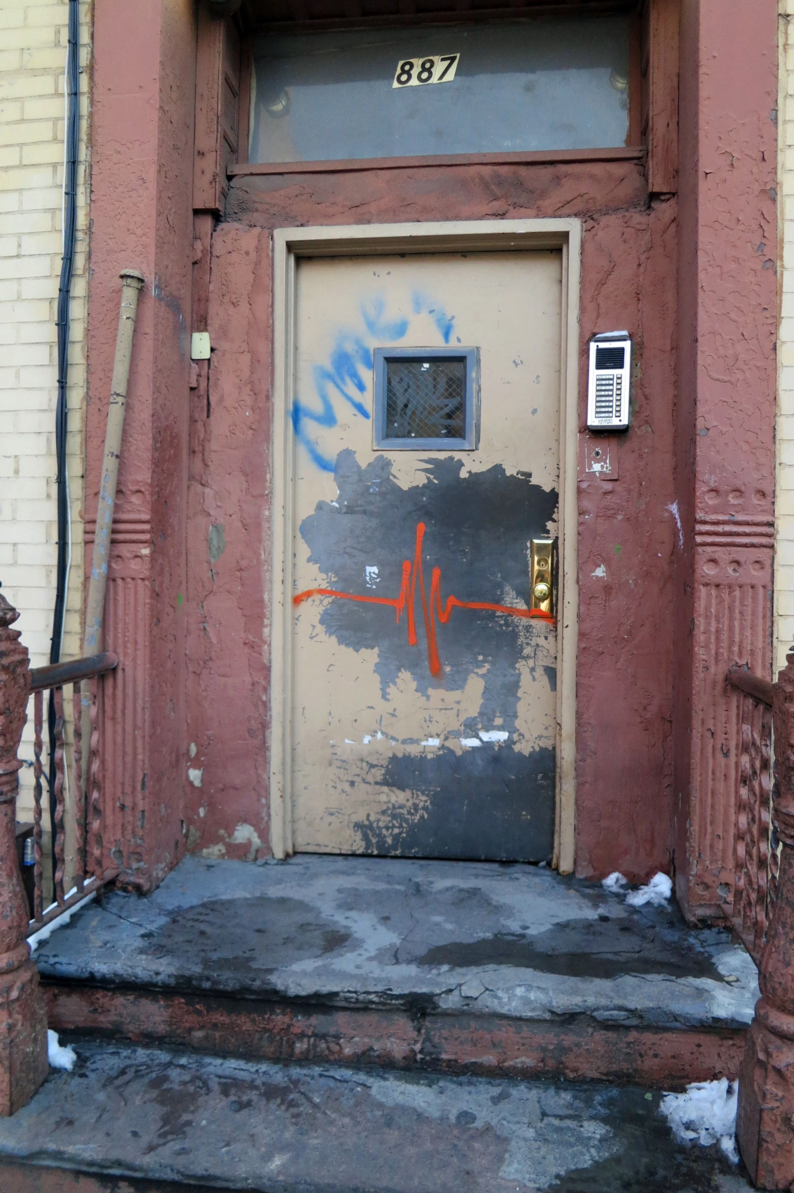 graffiti on the door of an old red building