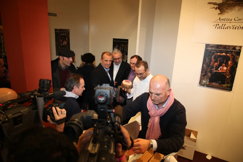 a group of men wearing scarves standing in a room