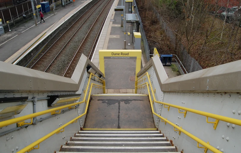 a yellow rail system with stairs leading up