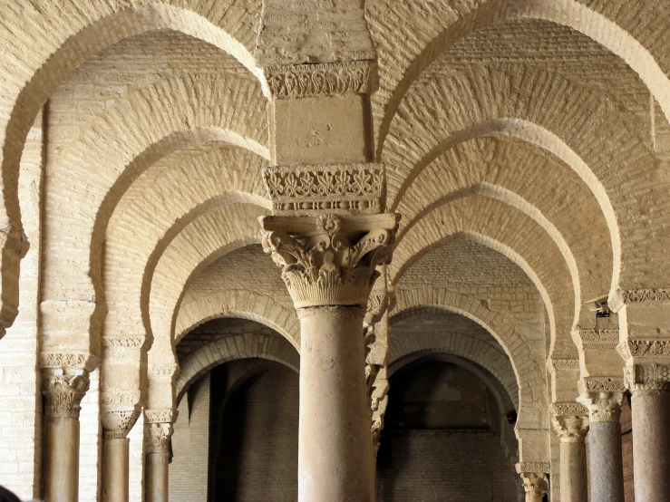 an empty and stone room with several arches