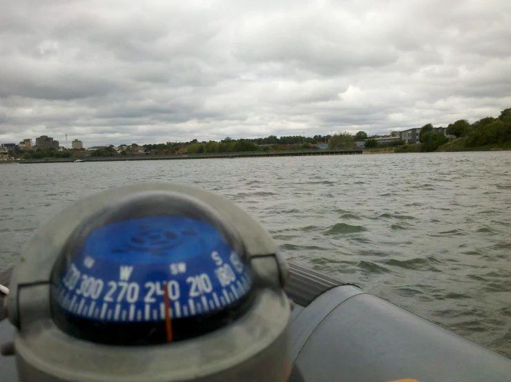 the view from the boat on the water with a compass point