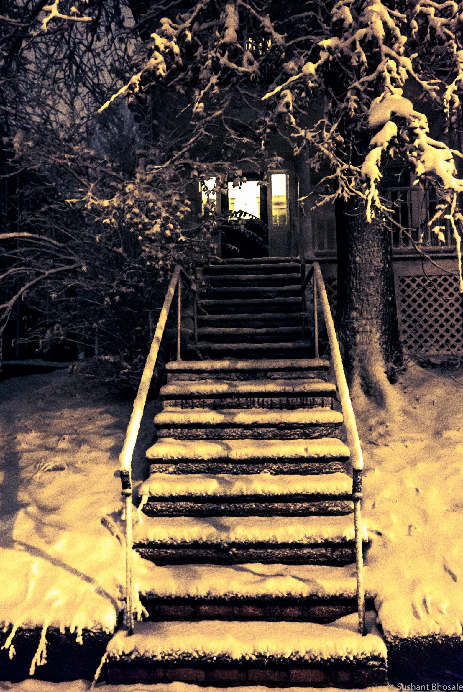 steps going up snow covered sidewalk in the winter