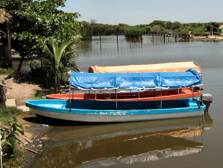 three empty rowboats next to the dock